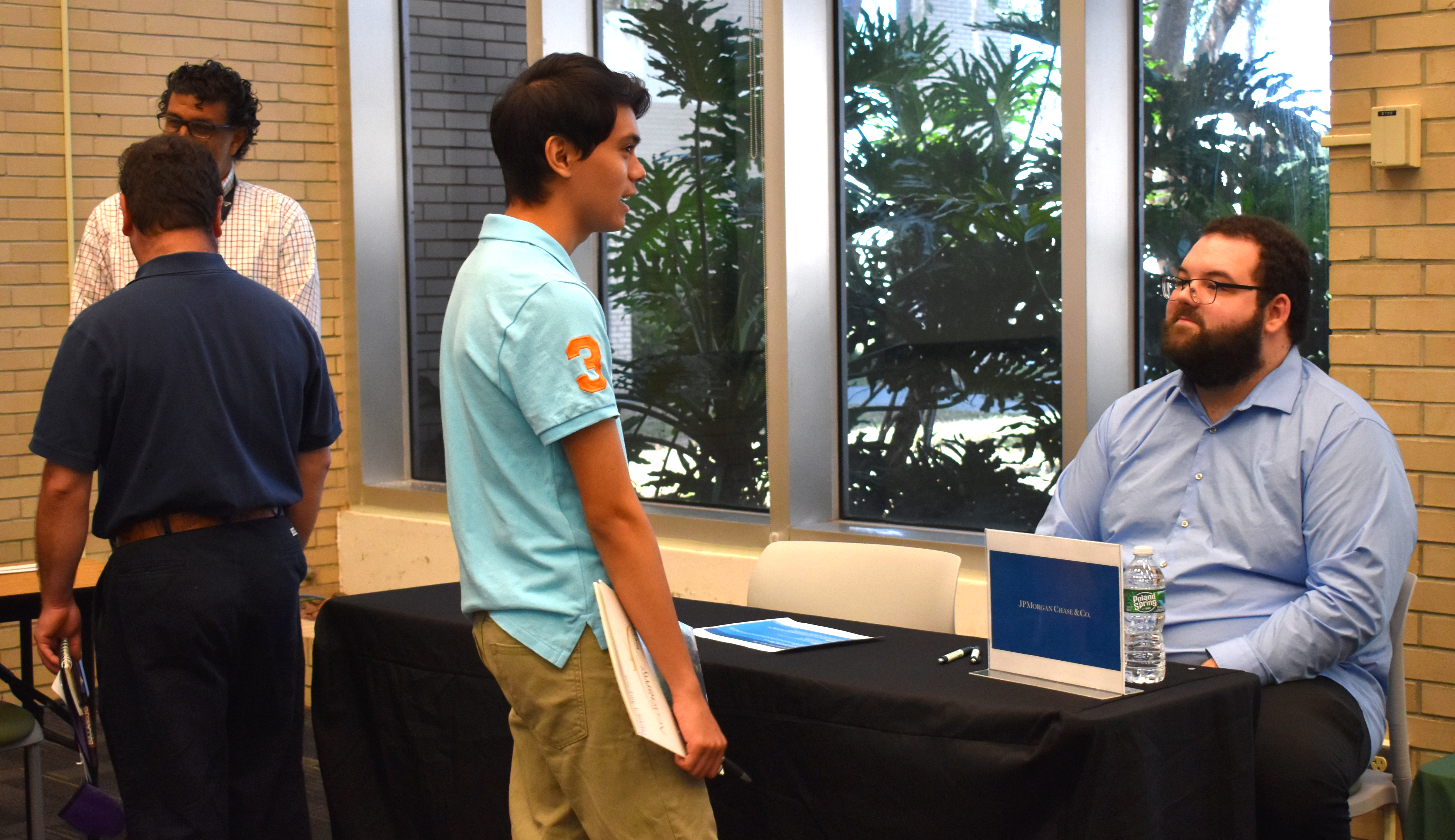 Image of LAUNCH students enganging with community leaders and business people at a mock job fair.